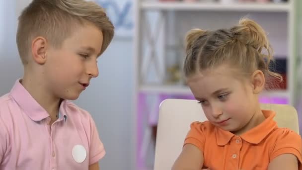 Hermano disculpándose con la hermana menor, tocándose la nariz, reconciliación — Vídeos de Stock