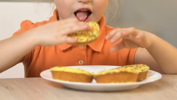 Klein meisje gretig eten lekker donuts, favoriete maaltijd, hoge suikerniveau — Stockvideo