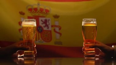 Bira gözlük tutan erkekler, arka planda, festival kutlama İspanyolca bayrak
