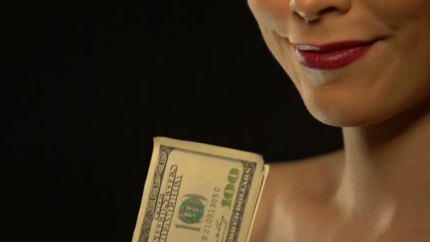 Елегантна дама показує купу доларів в камеру ізольовано на чорному тлі — стокове відео