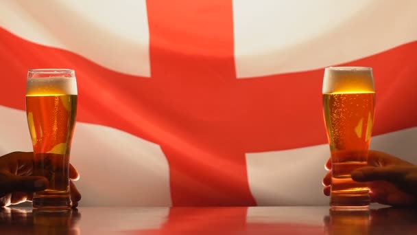 Fans holding beer glasses, English flag on background sports team support in pub — Stock Video