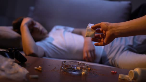 Наркоторговец рука предлагает белый порошок наркозависимому подростку, вред — стоковое видео