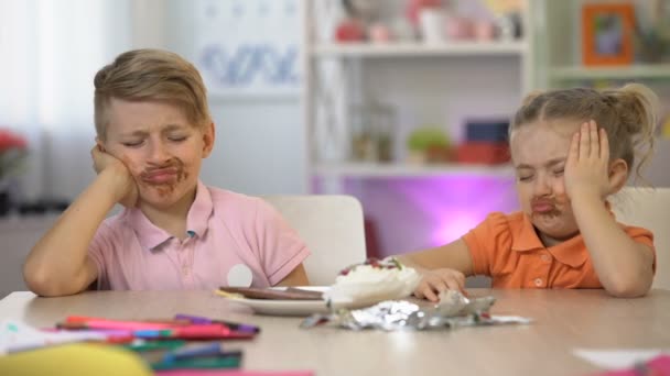 Two Children Smeared Chocolate Sitting Table Stomach Pain Overeating — Stock Video
