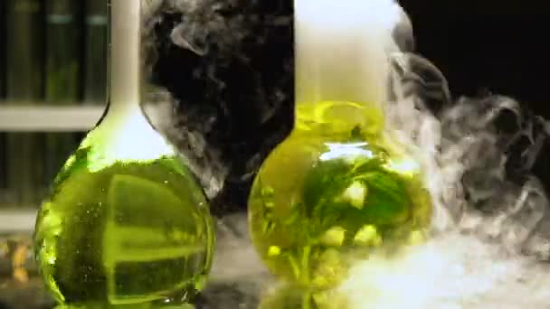 Yayan koyu arka plan üzerinde duman kaynama şişeler kimyasal sıvılarda ayıklanıyor — Stok video