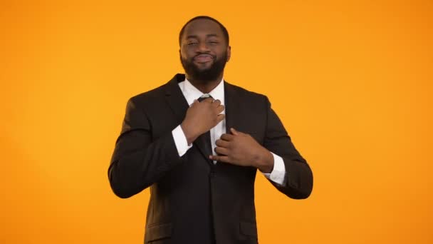 Stylish african-american male adjusting formal suit dry-cleaning quality garment — Stock Video