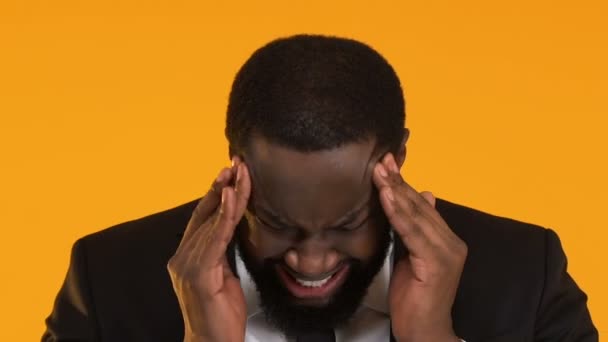 Man in suit massaging head, suffering from migraine pain, stressful work result — Stock Video