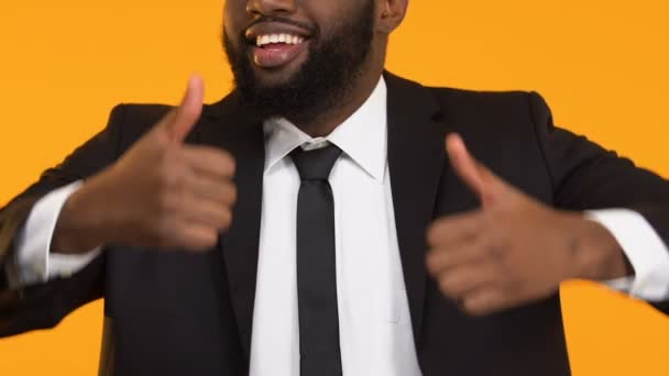 Smiling African-American man in suit showing thumbs up, career promotion — 图库视频影像