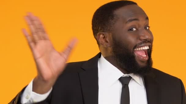 Glad man in suit waving hand to say hello, meeting important business partner — Stock Video