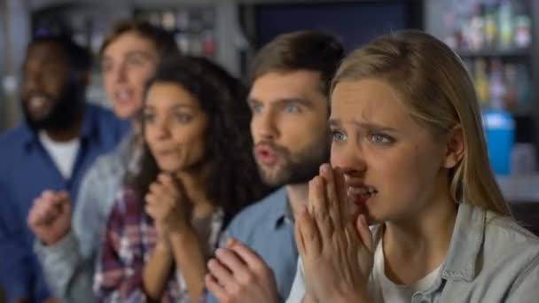 Les supporters de l'équipe bouleversés regardent le championnat en ligne, enracinant pour la compétition de buts 