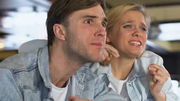 Caucasian couple watching match in bar, upset about favorite team losing game — Stock Video