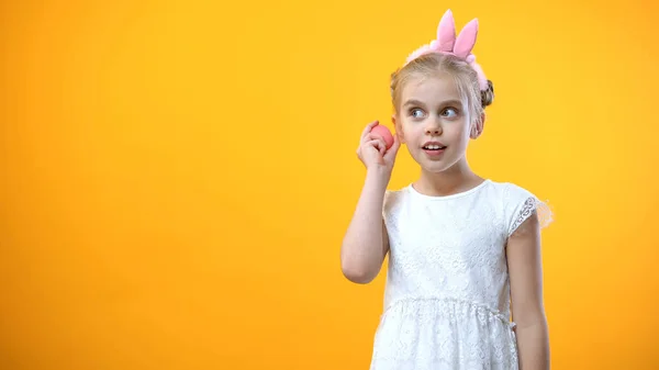 Cute Girl White Dress Listening Pink Egg Yellow Background Festival — Stock Photo, Image