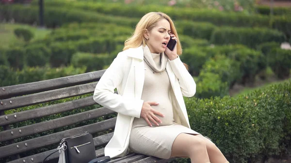 Mujer Embarazada Preocupada Llamando 911 Sintiendo Dolor Vientre Sentada Banco —  Fotos de Stock