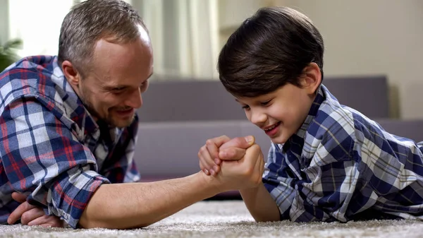 Cheerful Father Son Arm Wrestling Floor Having Fun Together Rival — Stock Photo, Image