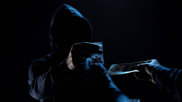 Person buying bag with dangerous toxic pills from drug dealer, addiction problem