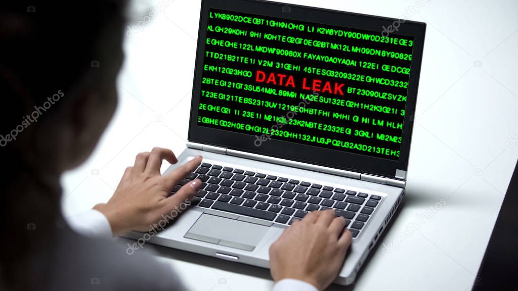 Data leak on laptop computer, woman working in office, cybercrime, close up