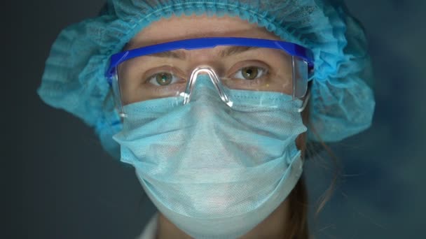 戴着安全眼镜看着相机的外科医生助理, 经验丰富的实验室工作人员 — 图库视频影像