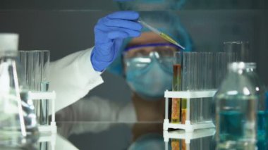 Laboratuar asistanı et numunesi ile tüpte kimyasal sıvı damlama, gıda kalitesi