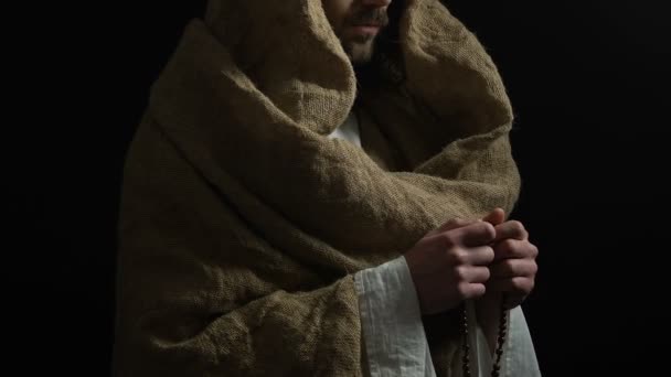 耶稣基督穿着长袍, 拿着一串珠子, 向上帝祈祷, 拯救恩典 — 图库视频影像