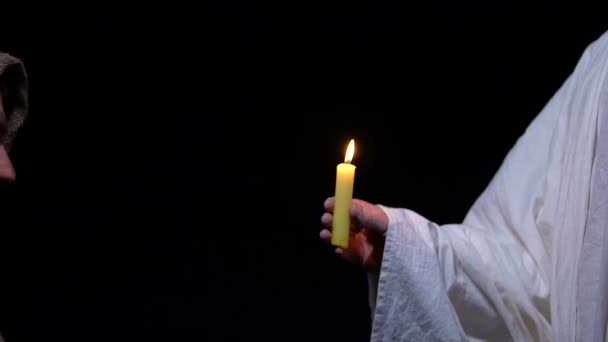 God giving burning candle to miserable man, hope and forgiveness sign, religion — Stock Video