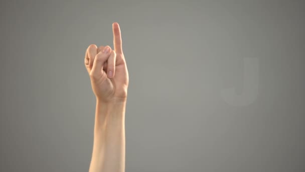 Buchstabe j in Gebärdensprache, Hand auf Hintergrund, Kommunikation für Gehörlose, Lektion — Stockvideo