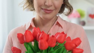 Güzel kadın laleler, kokulu 8 Mart kutluyor kameraya gülümseyen