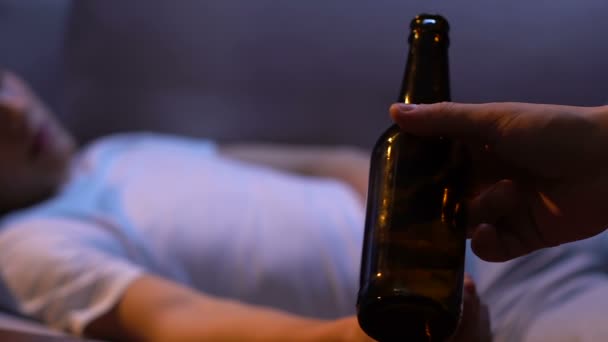 Męskiej dłoni dając butelki piwa do młodych nastolatek, strony domu, trudny wiek — Wideo stockowe