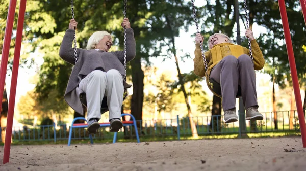 Duas Mulheres Idosas Rindo Equitação Balanços Parque Amigos Idosos Aposentadoria — Fotografia de Stock