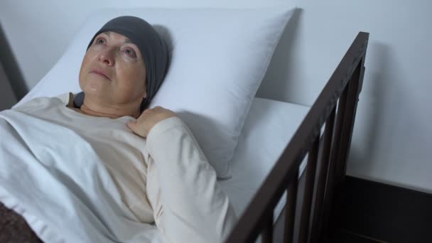 Depressed female patient suffering cancer lying in sickbed, incurable disease — Stock Video