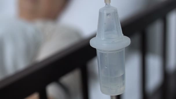 Close up of dropper near sick patients bed, hospital resuscitation, hard disease — Stock Video