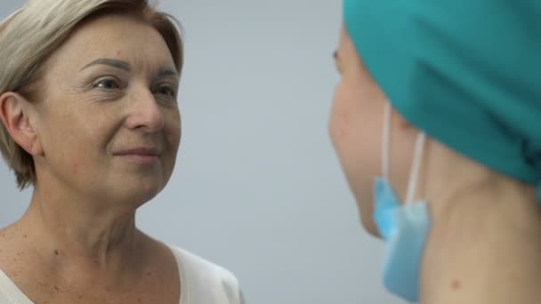 Sorrindo senhora idosa abraçando enfermeira, remissão após a doença fatal, boas notícias — Vídeo de Stock