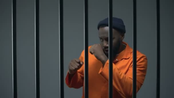 Africano-americano prisioneiro sombra boxe na cela, hobby disponível, criminoso — Vídeo de Stock