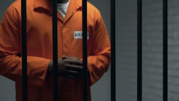 Коррумпированный офицер, дающий черному заключенному преступный клинок, подготовку к восстанию — стоковое видео