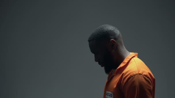 Afro-american imprisoned male praying looking up at light, coming to god — Stock Video