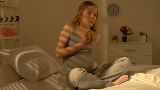 Депрессивная беременная женщина жует пончик, пьет расстройство пищевого поведения, материнский стресс — стоковое видео