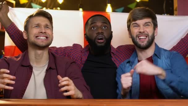 Multiracial sports fans waving English flag in bar displeased about match losing — Stock Video