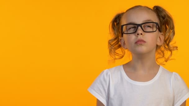 Sprytny żeński dzieciak w okularach mający pomysł, ciekawość wiedzy, szablon, zbliżenie — Wideo stockowe