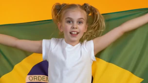 Kleine fan Kid zwaaiende vlag van Brazilië, juichen voor nationale sport team, ondersteuning — Stockvideo