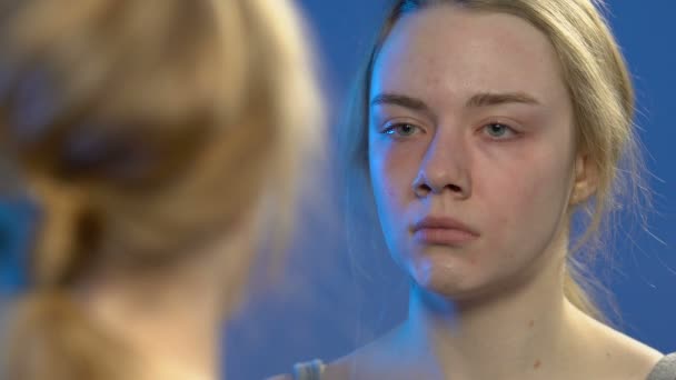 Unge dame som ser på refleksjon i speil og gråt, tenåringsproblemer, følelser – stockvideo