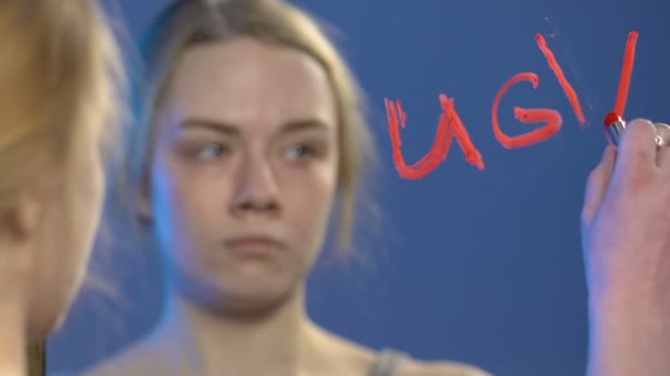 Sconvolto teen girl scrittura con parola rossetto brutto su specchio, bassa autostima — Video Stock