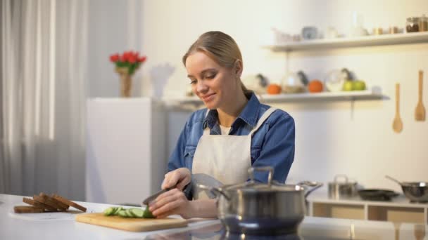 Young woman smelling cooked soup with disgusted face expression, spoiled food — Stock Footage Young woman smelling cooked soup with disgusted face expression, spoiled food Video Clip