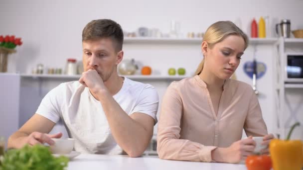 Jovem casal sentado silenciosamente na cozinha após discussão, crise no relacionamento — Vídeo de Stock