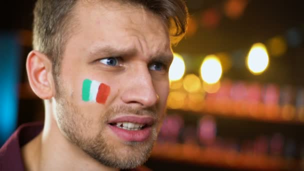 Disappointed football fan with italian flag on cheek making facepalm, failure — Stock Video