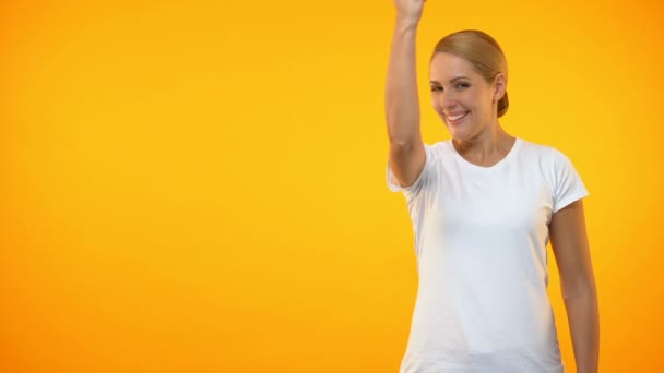 Confident happy female showing yes gesture on bright background, achievement — Stock Video