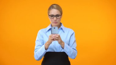 Young cheerful business woman reading email on smartphone, successful deal