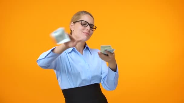 Положительная женщина в официальном костюме разбрасывается долларами, финансовая независимость — стоковое видео