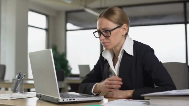 Female employee reading bad news on email, angrily closing laptop, dismissal — Stock Video