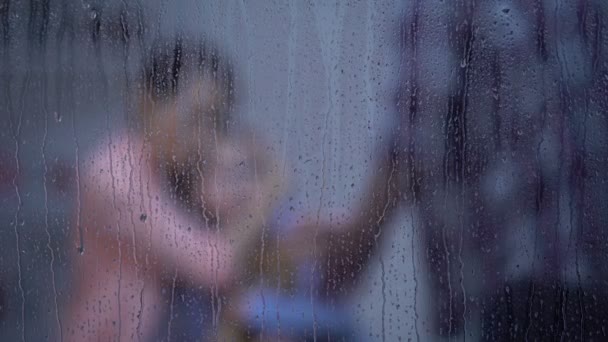 Mother hugging daughter, protecting from angry father on rainy day, harassment — Stock Video