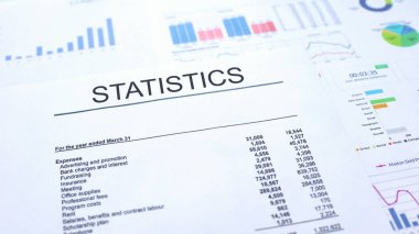Tabloüzerinde yatan istatistik resmi belge, grafik grafikleri ve diyagramları, metin