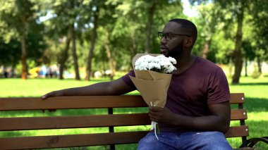 Çiçek buketi ile şaşırttı adam bankta oturan ve kadın bırakarak bakıyor