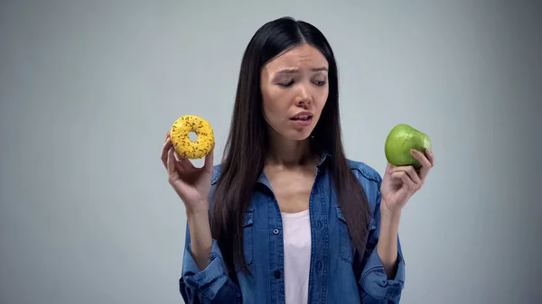 Asian Woman Holding Sweet Greasy Donut Juicy Green Apple Hands — Stock Photo, Image